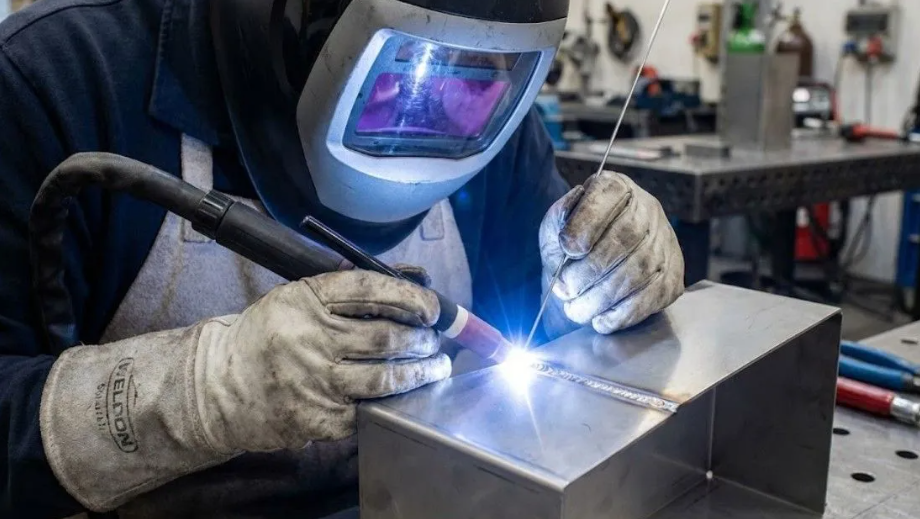 Certified welder fabricating a stainless steel structure