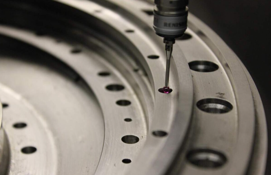 Coordinate measuring machine inspecting a machined part